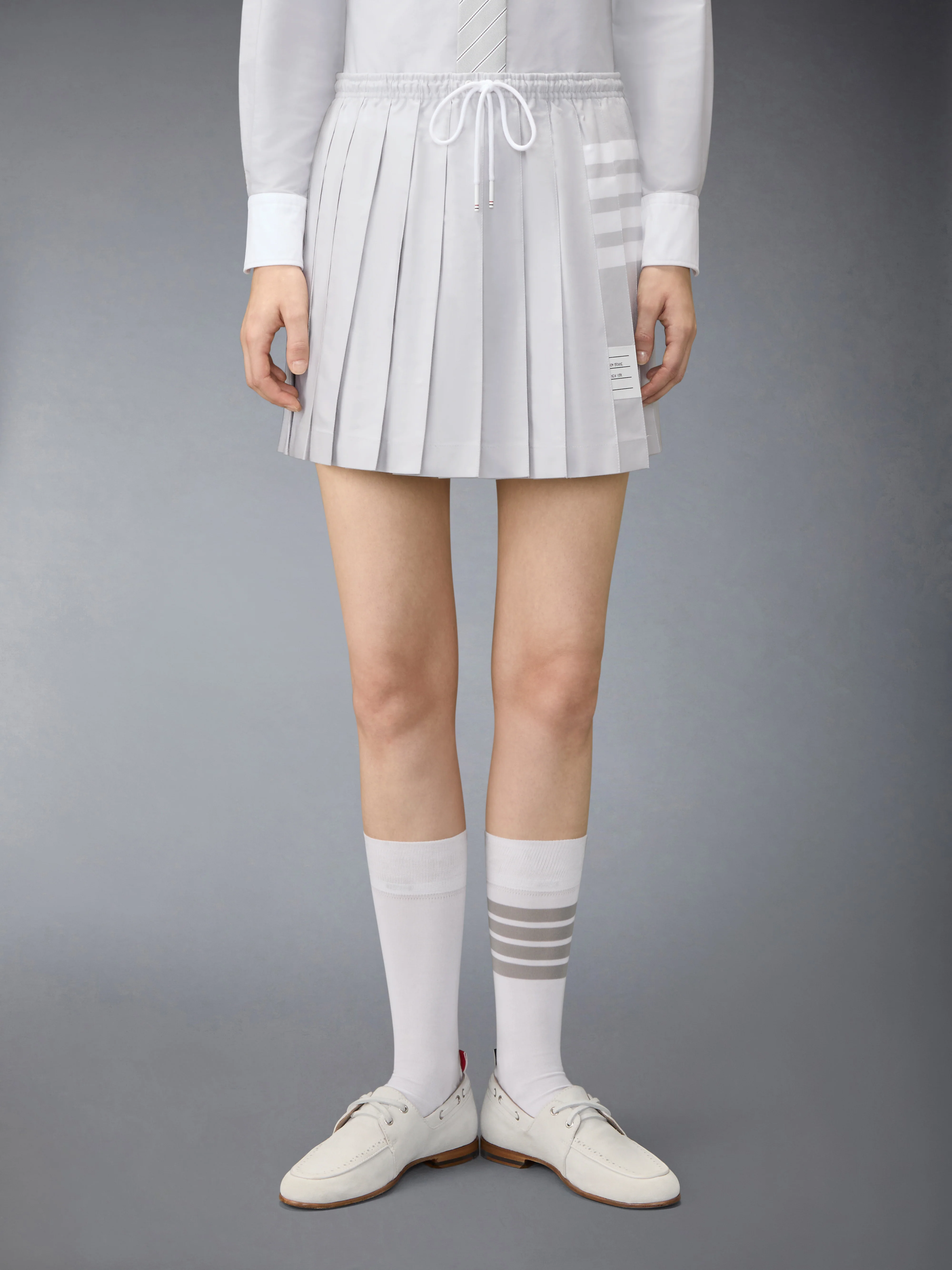 OXFORD 4-BAR DRAWSTRING PLEATED MINI SKIRT